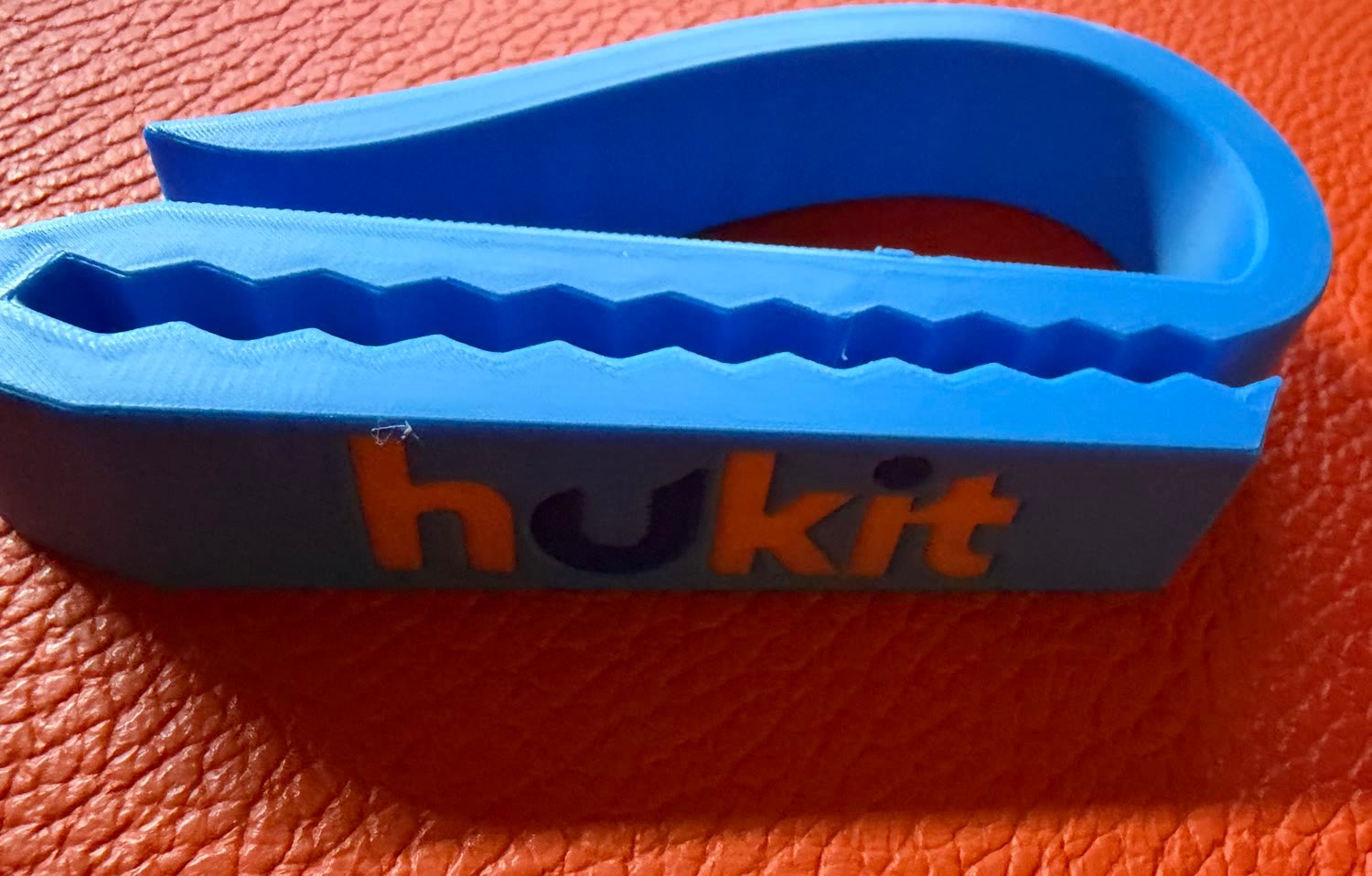 A real HUKIT clip with the raised hukit logo on its toothed arm